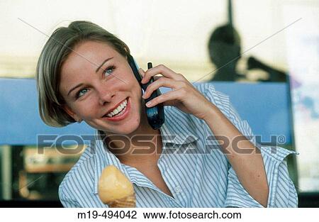 girl eating ice cream on cell phone View Large Photo Image Stock Image - girl eating ice cream on cell phone. Fotosearch