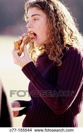 Girl eating pizza View Large Photo Image Picture - Girl eating pizza. Fotosearch