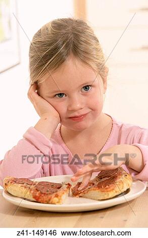 Stock Photograph - Girl eating pizza. Fotosearch
