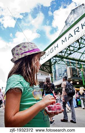 Girl eating raspberries at the Borough Market in London. View Large Photo Image Stock Image - Girl eating raspberries at the Borough Market in London.. Fotosearch