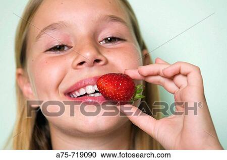 Girl eating strawberries View Large Photo Image Stock Image - Girl eating strawberries. Fotosearch