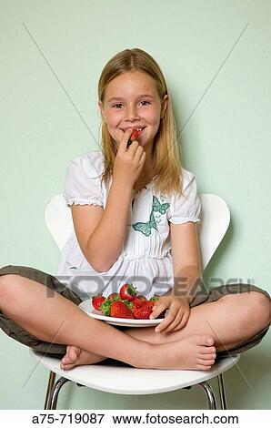 Girl eating strawberries View Large Photo Image Stock Photo - Girl eating strawberries. Fotosearch