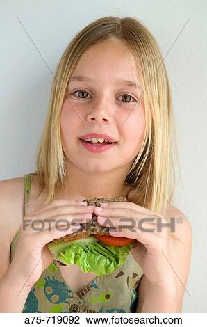 Girl eating vegetable sandwich View Large Photo Image Stock Image - Girl eating vegetable sandwich. Fotosearch