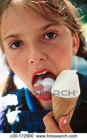 Girl enjoys an ice cream cone View Large Photo Image Stock Image - Girl enjoys an ice cream cone. Fotosearch