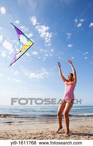 girl flying a kite View Large Photo Image Stock Photo - girl flying a kite. Fotosearch