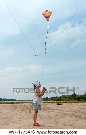 Girl flying kite on Vistula river beach, Poland View Large Photo Image Stock Photograph - Girl flying kite on Vistula river beach, Poland. Fotosearch
