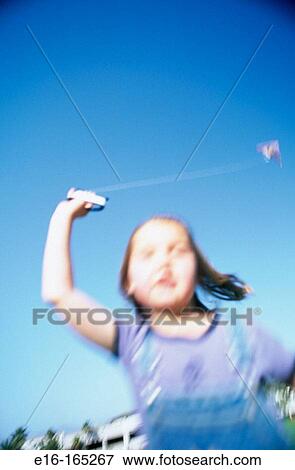 Girl flying kite View Large Photo Image Stock Photo - Girl flying kite. Fotosearch