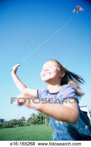 Girl flying kite View Large Photo Image Stock Photo - Girl flying kite. Fotosearch