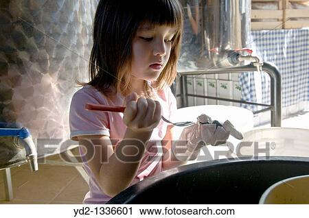 Girl forking olives for salting View Large Photo Image Stock Image - Girl forking olives for salting. Fotosearch