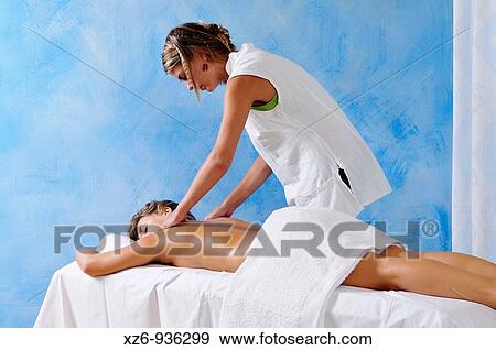 Girl getting back massage View Large Photo Image Stock Photo - Girl getting back massage. Fotosearch