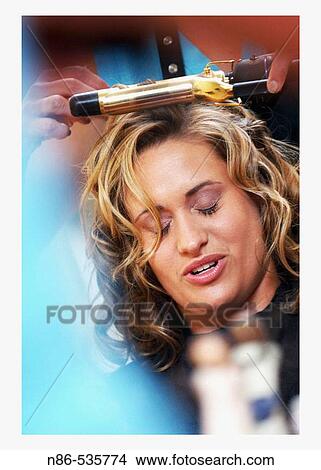 Picture - Girl getting hair done. Fotosearch