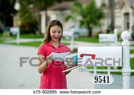 Stock Photography - girl getting the mail. Fotosearch
