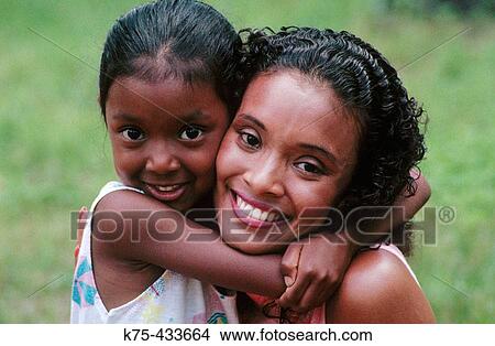 Girl giving her mom a big hug View Large Photo Image Picture - Girl giving her mom a big hug. Fotosearch