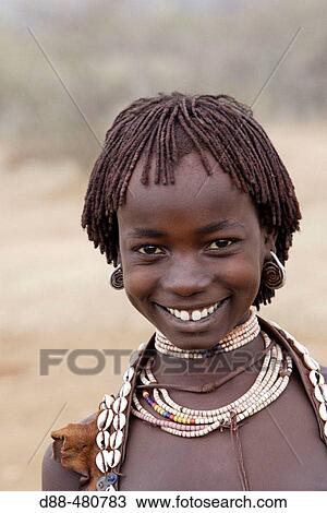 Girl Hamer tribe. Lower basin of Omo river. Copper skin with very fine features and wear metal arm and leg bracelets, shells and beads. Gamo Gofa region. South Ethiopia. View Large Photo Image Stock Image - Girl Hamer tribe. Lower basin of Omo river. Copper skin with very fine features and wear metal arm and leg bracelets, shells and beads. Gamo Gofa region. South Ethiopia.. Fotosearch