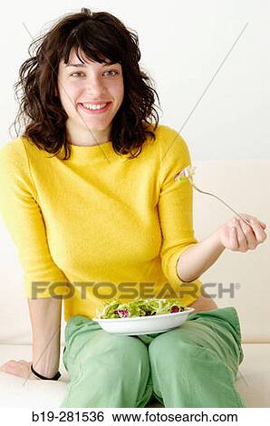 Stock Photograph - Girl having a salad. Fotosearch