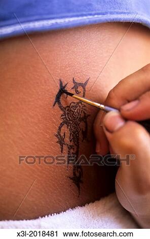 Girl having a tattoo made on her back View Large Photo Image Stock Image - Girl having a tattoo made on her back. Fotosearch
