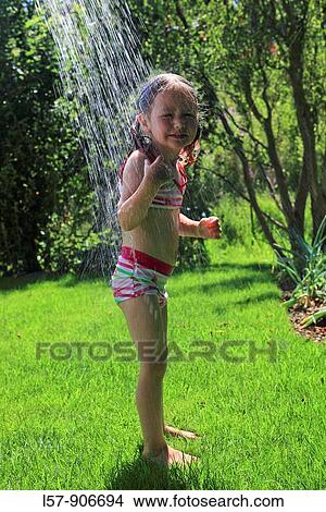 girl having shower outdoors, Switzerland View Large Photo Image Picture - girl having shower outdoors, Switzerland. Fotosearch
