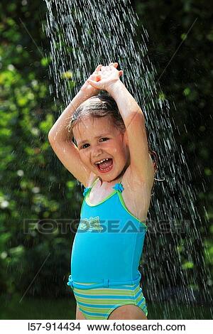 Picture - girl having shower outdoors, Switzerland. Fotosearch
