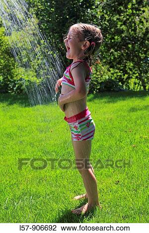 girl having shower outdoors, Switzerland View Large Photo Image Stock Image - girl having shower outdoors, Switzerland. Fotosearch