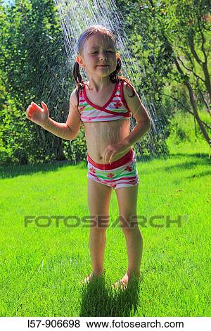 girl having shower outdoors, Switzerland View Large Photo Image Stock Photo - girl having shower outdoors, Switzerland. Fotosearch