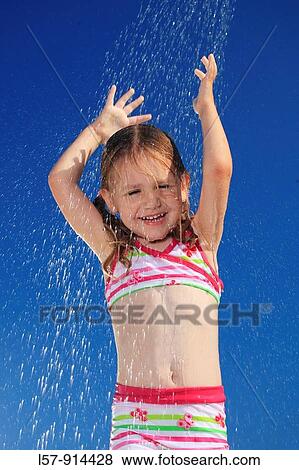 Stock Photo - girl having shower outdoors, Switzerland. Fotosearch
