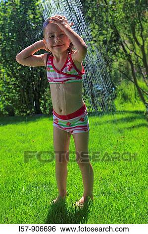 Stock Photograph - girl having shower outdoors, Switzerland. Fotosearch
