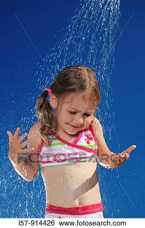 Stock Photograph - girl having shower outdoors, Switzerland. Fotosearch