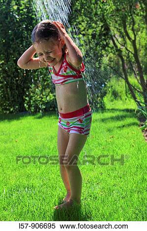 girl having shower outdoors, Switzerland View Large Photo Image Stock Photography - girl having shower outdoors, Switzerland. Fotosearch
