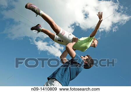 Girl held aloft flying View Large Photo Image Stock Photo - Girl held aloft flying. Fotosearch