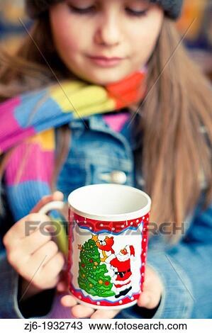 Girl holding a tea with Santa Claus View Large Photo Image Stock Image - Girl holding a tea with Santa Claus. Fotosearch