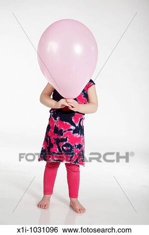 Stock Photograph - Girl holding balloon. Fotosearch
