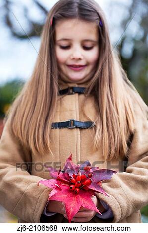 Girl holding fallen leaves and rose hips. View Large Photo Image Stock Photo - Girl holding fallen leaves and rose hips.. Fotosearch