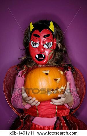 Girl holding jack o? lantern View Large Photo Image Stock Image - Girl holding jack o? lantern. Fotosearch