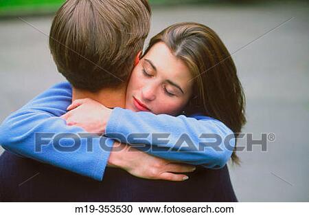 Stock Image - girl hugging her boyfriend. Fotosearch