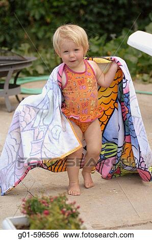 Girl in a beach towel after swiming View Large Photo Image Stock Photograph - Girl in a beach towel after swiming. Fotosearch