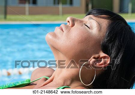 Stock Image - Girl in a pool.. Fotosearch