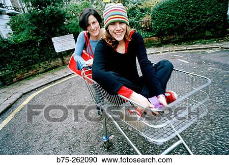 Girl in a shopping cart View Large Photo Image Stock Image - Girl in a shopping cart. Fotosearch