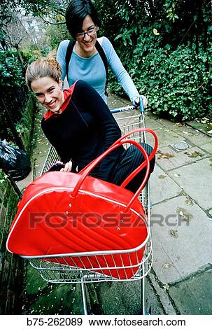 Girl in a shopping cart View Large Photo Image Stock Photo - Girl in a shopping cart. Fotosearch
