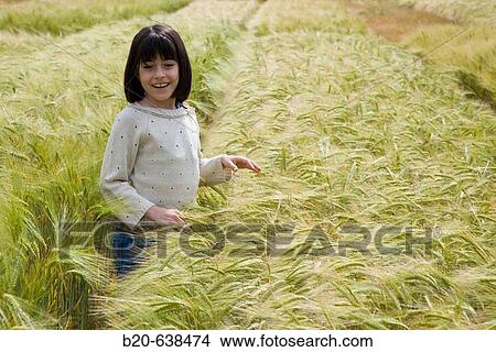 Picture - Girl in grain field. Arkaute, Alava, Euskadi, Spain. Fotosearch