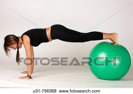 Girl in her early 40s exercising with a ball View Large Photo Image Stock Photo - Girl in her early 40s exercising with a ball. Fotosearch