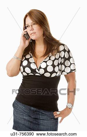 Stock Image - Girl in her early 40s talking on the phone. Fotosearch
