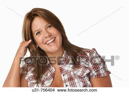 Girl in her late 30s pretending to be talking on the phone in a studio setting smiling at the camera View Large Photo Image Picture - Girl in her late 30s pretending to be talking on the phone in a studio setting smiling at the camera. Fotosearch