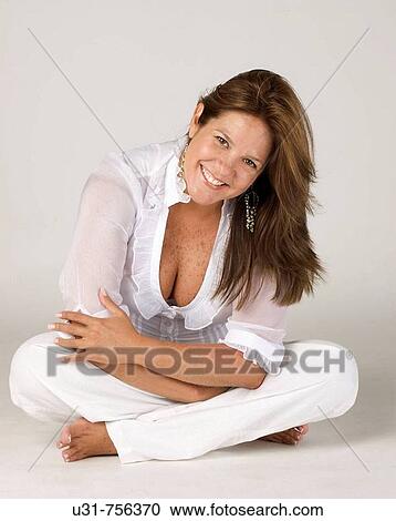 Girl in her late 30s sitting down on a studio setting smiling at the camera View Large Photo Image Stock Image - Girl in her late 30s sitting down on a studio setting smiling at the camera. Fotosearch