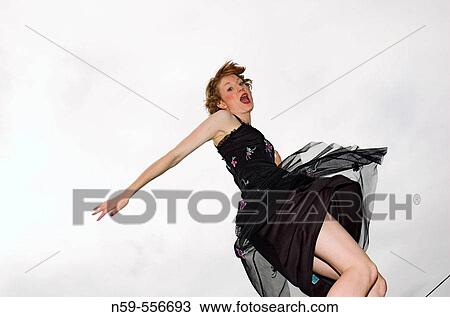 Girl in party dress jumping with excitement. View Large Photo Image Stock Image - Girl in party dress jumping with excitement.. Fotosearch