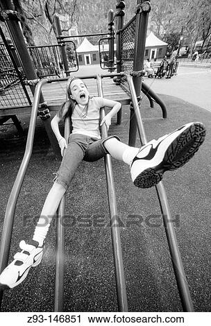 Stock Image - Girl in playground. New York City. USA. Fotosearch