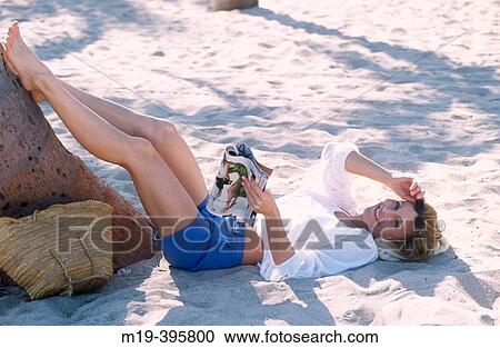 girl in shorts relaxing at the beach View Large Photo Image Stock Image - girl in shorts relaxing at the beach. Fotosearch