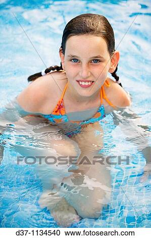 Stock Image - Girl in swimming pool. Fotosearch