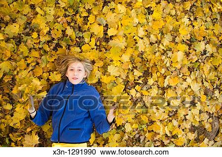 Girl in the leaves View Large Photo Image Stock Image - Girl in the leaves. Fotosearch
