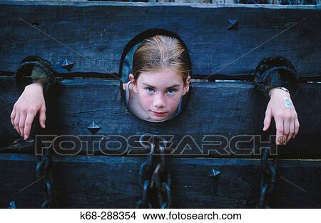 girl in the stocks View Large Photo Image Picture - girl in the stocks. Fotosearch
