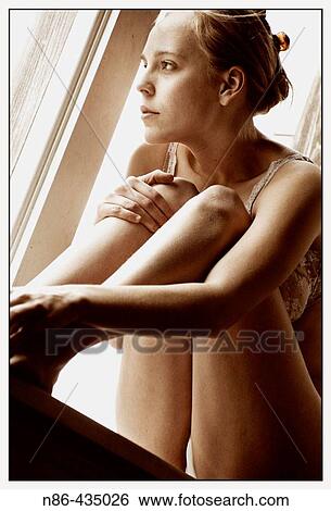 Girl in underwear perched on window ledge View Large Photo Image Stock Photograph - Girl in underwear perched on window ledge. Fotosearch